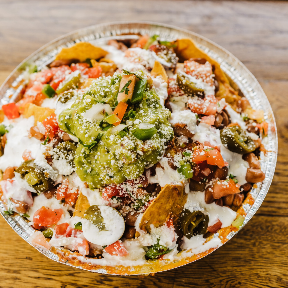Burrito Republic's loaded nachos with guacamole, sour cream, jalapeños, tomatoes, and cheese.