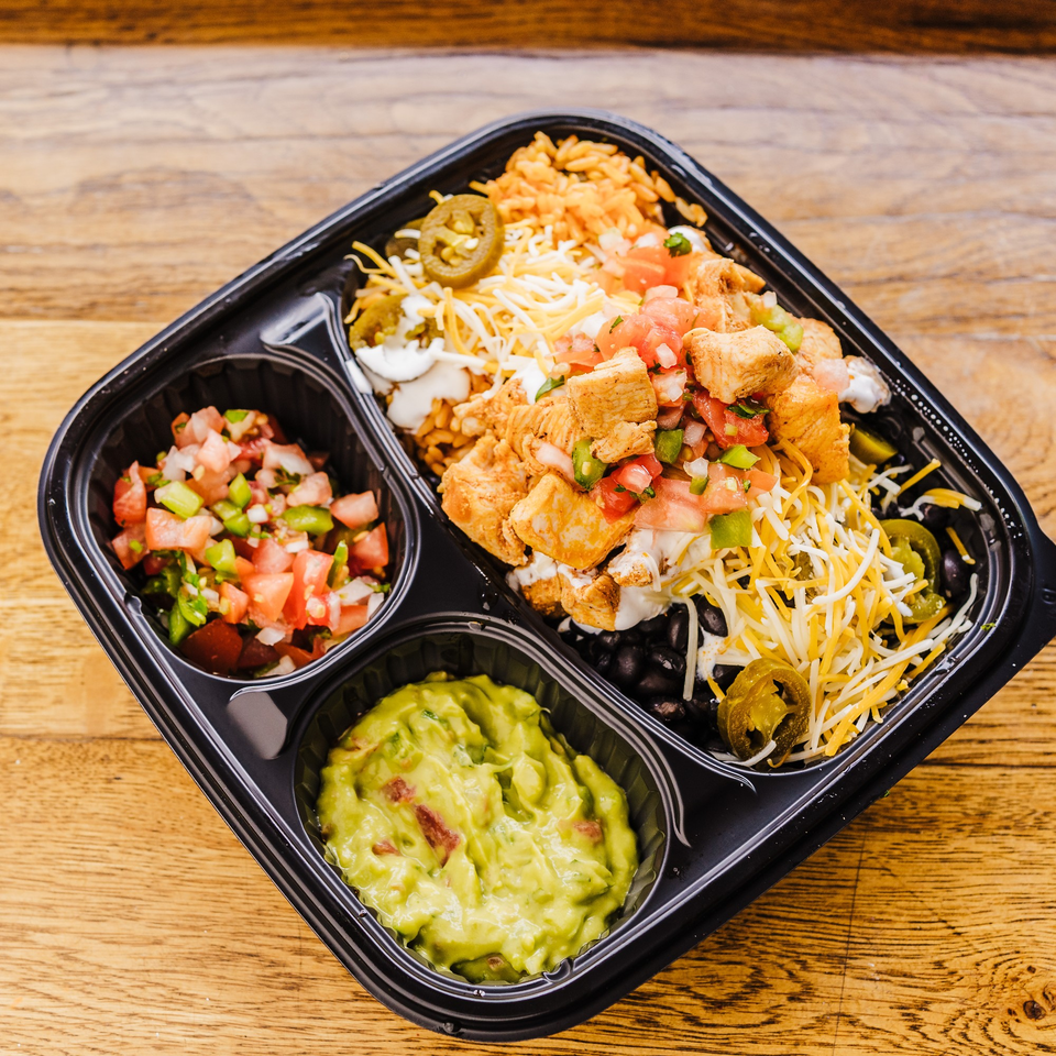 Burrito Republic's chicken burrito bowl with rice, beans, salsa, guacamole, cheese, and jalapeños.